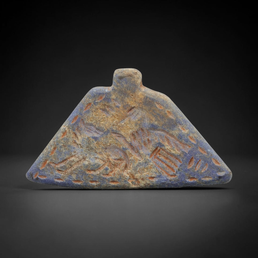 Ancient Lapis Lazuli Amulet - Near Eastern Animal Figure, 72ZT: Carved from lapis lazuli, this amulet features a relief scene depicting two confronting animal figures, rendered in the stylized glyptic tradition of the ancient Near East. Incised details define the