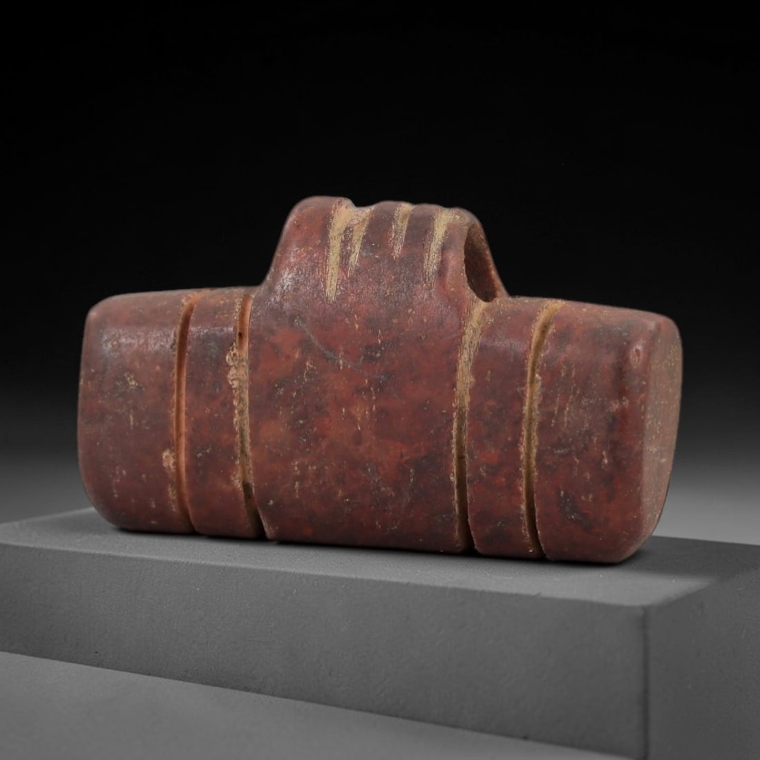 Ancient Egyptian Stone Fist Amulet - Protective Carved Pendant, 84AE: Carved from stone, this ancient Egyptian fist amulet features a stylized fist form with linear decorative patterns, a motif associated with protection and power in Egyptian amuletic art from the Late