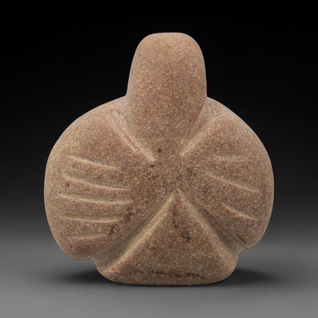 Ancient Stone Bird - Near Eastern Amulet Figurine, 25XR: Carved from warm reddish-brown stone, this amulet depicts a stylized bird with a rounded head, broad wing-like body, and incised linear details representing feather patterns. The geometric, abstract f