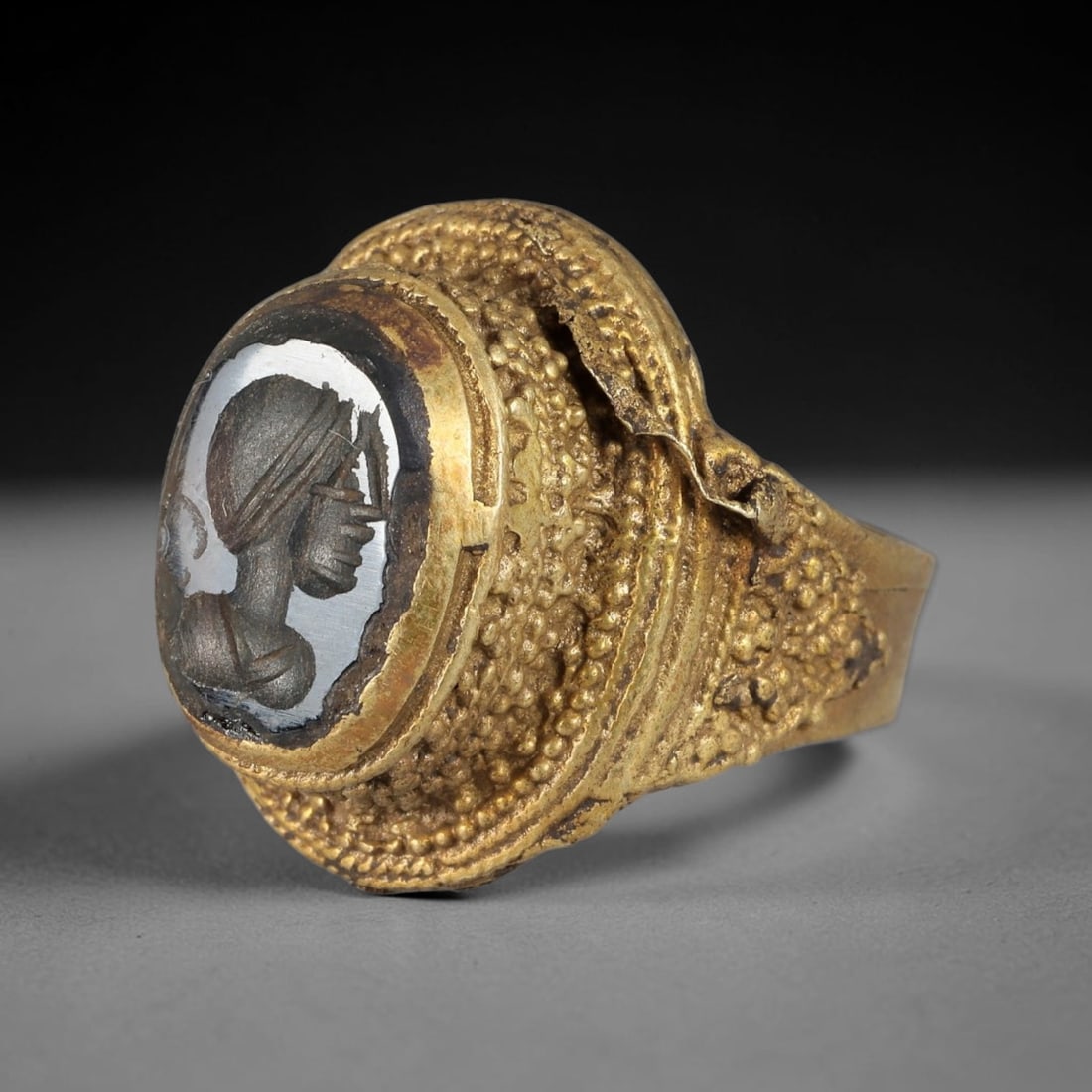 Antique Qajar Dynasty Brass Intaglio Ring - Size 8 US, 70BA: Crafted from brass, this ring features an intricately carved intaglio panel depicting a profile figure, executed in the distinctive Qajar style. The brass band exhibits a textured, granular finish typ