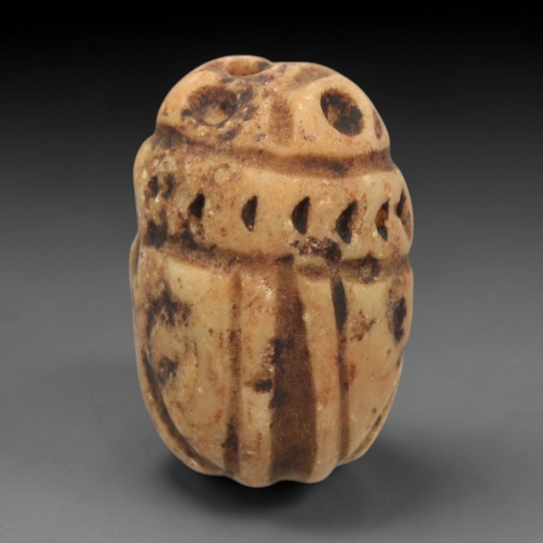 Ancient Steatite Scarab Stamp Seal - Near Eastern Anthropomorphic Figure, 34ZS: Carved from pale beige steatite with natural dark patination, this Near Eastern scarab stamp seal features a dorsal scarab pattern with incised linear elytra segments and decorative perforations, whil