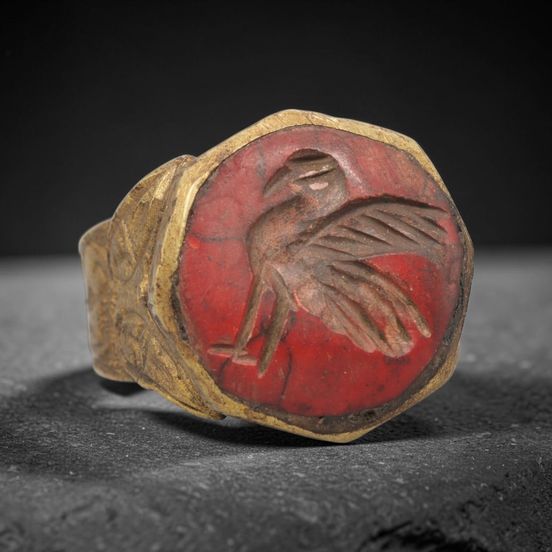 Antique Qajar Dynasty Bird Intaglio Ring - Size 9 US, 77ZX: Crafted from gilt metal with a faceted bezel, this ring features a carved red stone intaglio at its center, depicting an incised bird motif with detailed wing and body rendering, typical of Qajar-era