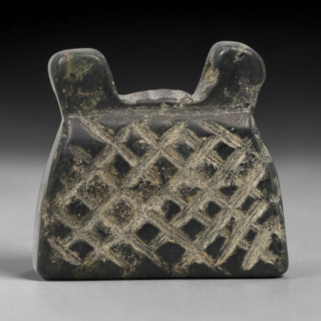 Ancient Near Eastern Dark Stone Shrine Amulet - Carved Pendant Figure, 47ZW: This amulet is carved from a dense, dark greenish-black stone, likely serpentine or steatite, with incised linear details defining its stylized shrine form. The piece features a trapezoidal main body