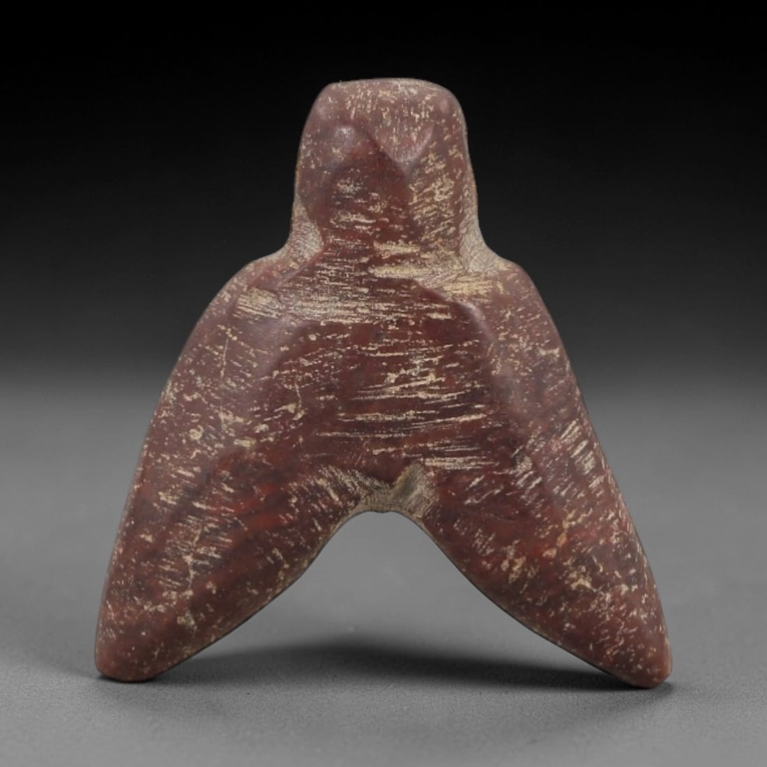 Ancient Egyptian Stone Amulet - Carved Ritual Pendant, 68AE: Carved from reddish-brown stone, this amulet features a stylized form with incised linear detailing, consistent with ancient Egyptian ritual pendants of the Late Period. The shape is designed for susp