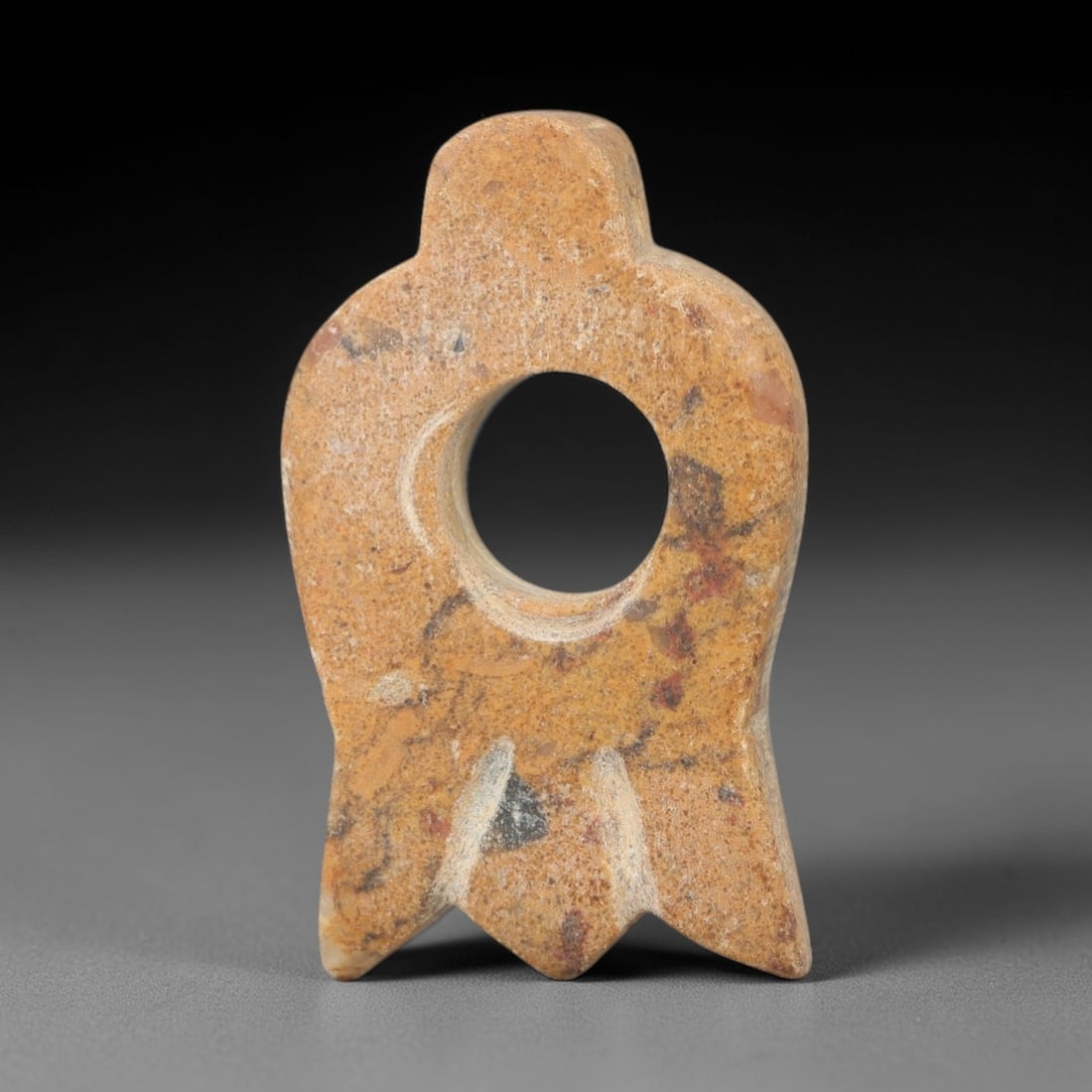 Ancient Stone Eye Idol - Near Eastern Ritual Figurine, 21AG: This amulet is carved from a single piece of mottled tan stone, exhibiting a granular texture with scattered dark mineral inclusions and a uniform matte patina across the surface. The form is schemati
