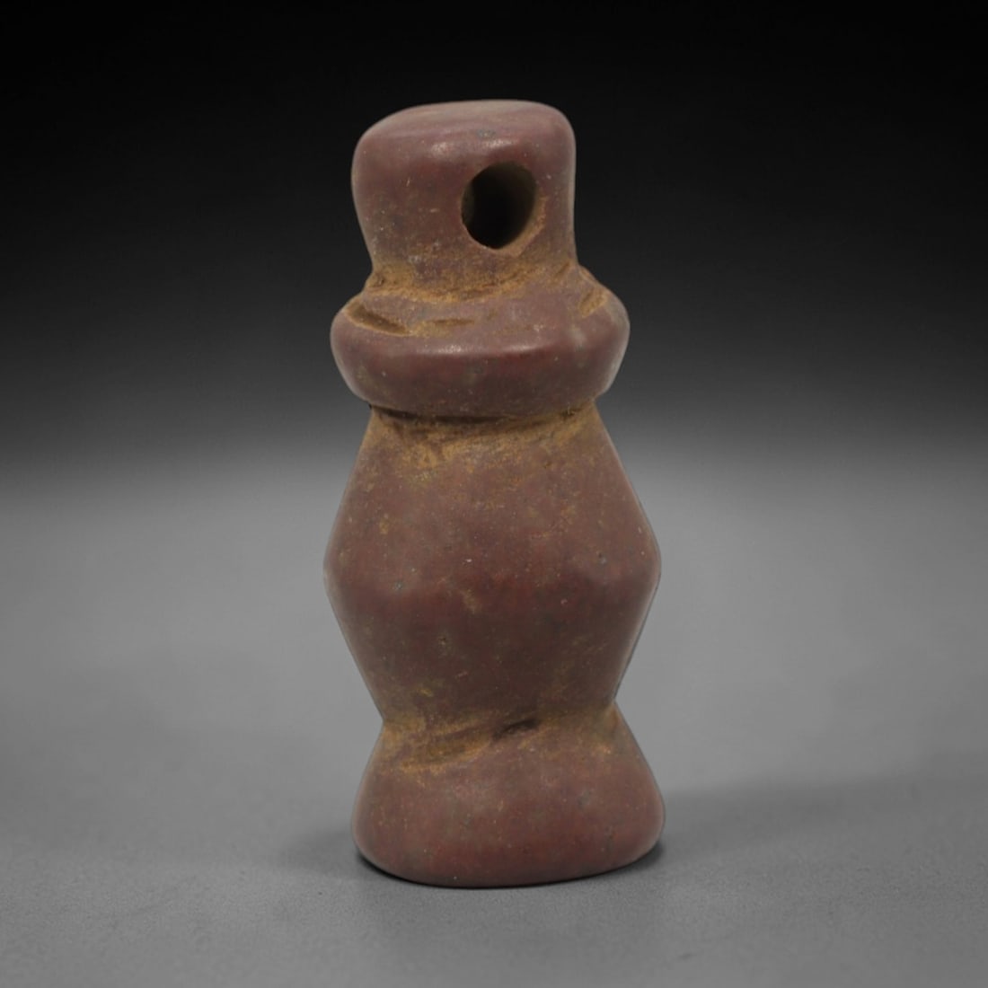Ancient Stone Abstract Anthropomorphic Amulet - Near Eastern Figurine, 29XQ: Carved from a dense, reddish-brown stone with a fine-grained texture, this amulet depicts a highly stylized, abstract anthropomorphic form with a bulbous head surmounted by a distinct suspension hole,