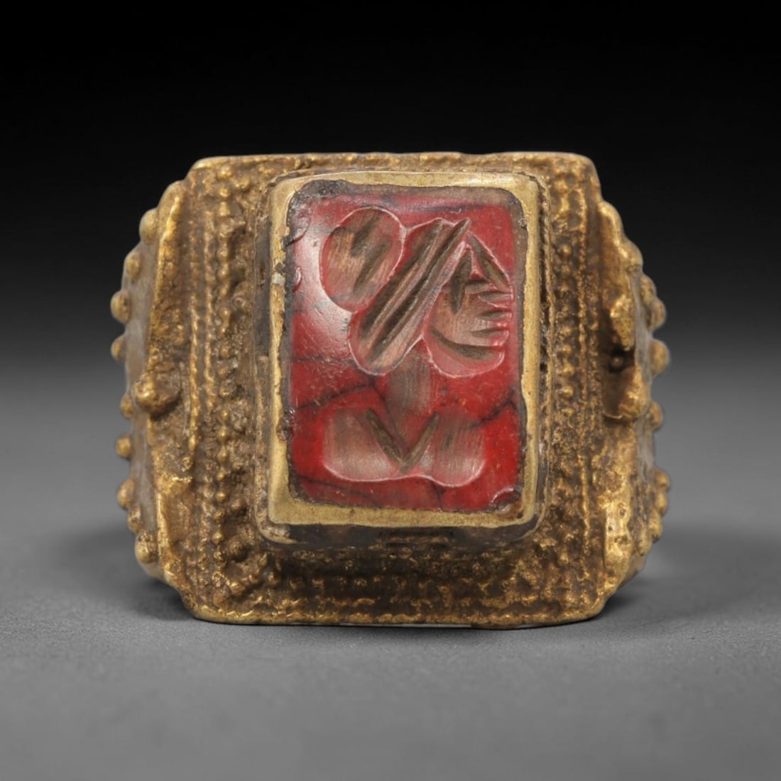 Antique Qajar Dynasty Brass Red Stone Intaglio Ring - Size 11 US, 73ZX: This antique Qajar dynasty brass intaglio ring features a square red stone intaglio inset carved with a detailed profile portrait, set within an ornate brass mount adorned with granular beading and te