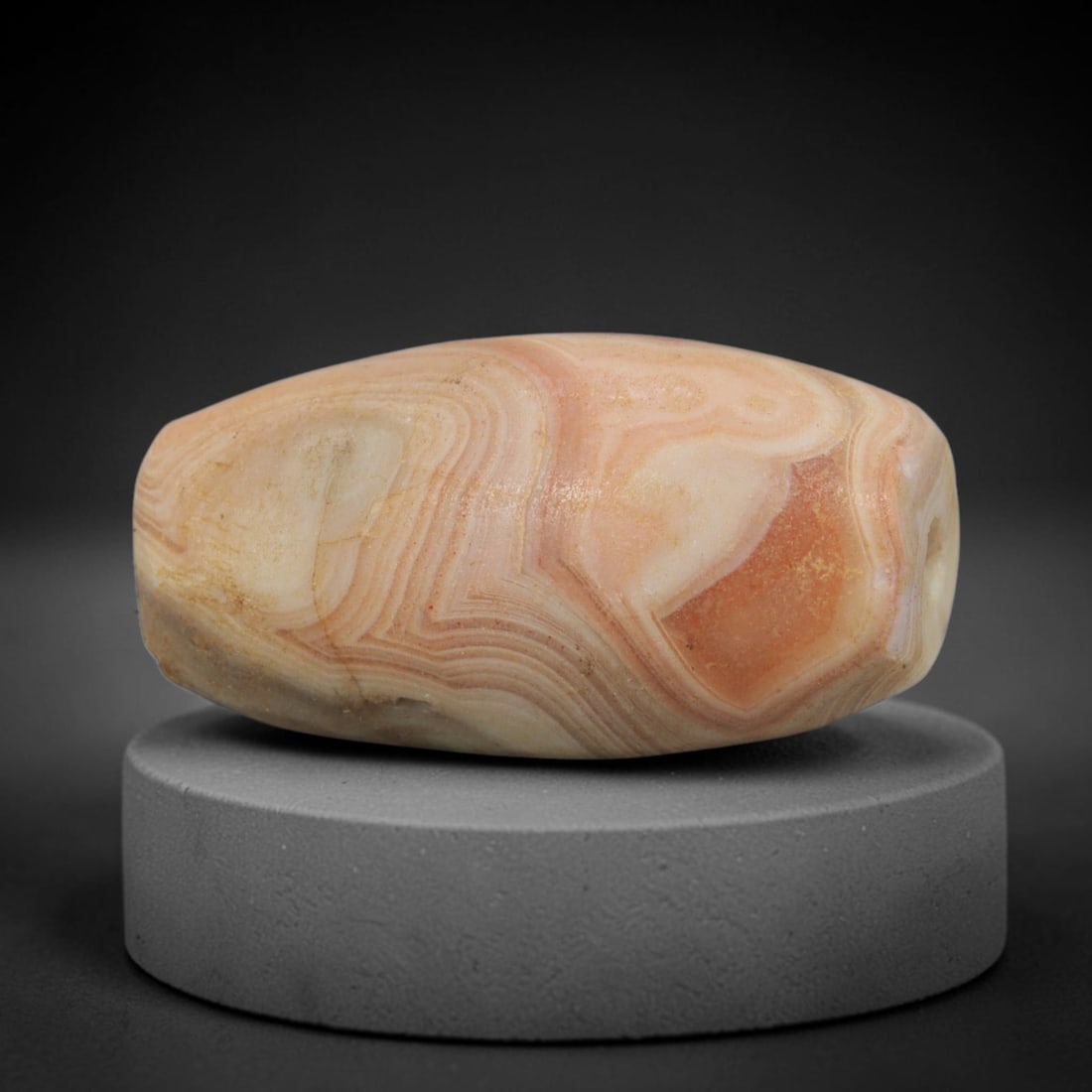 Ancient Banded Agate Bead - Western Asiatic Amulet: This bead is masterfully carved from naturally banded translucent agate, showcasing exceptional lapidary craftsmanship consistent with ancient bead-making traditions of the Indus Valley and Bactrian r