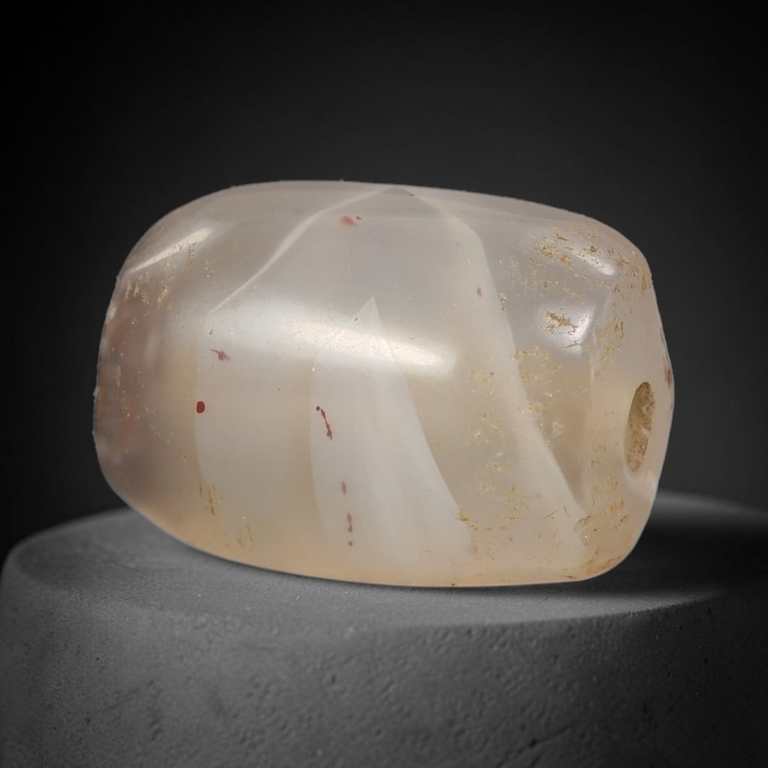 Ancient Agate Bead - Silk Road Miniature Amulet: Carved from translucent banded agate, the bead features a short cylindrical barrel form with a smooth, polished surface that highlights the stone's pale milky white base and subtle internal banding. A