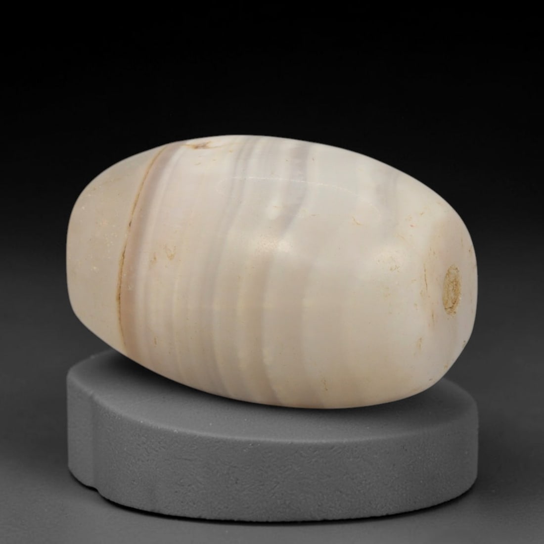 Ancient Agate Bead - Western Asiatic Amulet, 65XT: This bead is carved from naturally banded agate, exhibiting fine lapidary workmanship consistent with ancient bead-making traditions of Western Asiatic regions including Bactria and the Silk Road corr