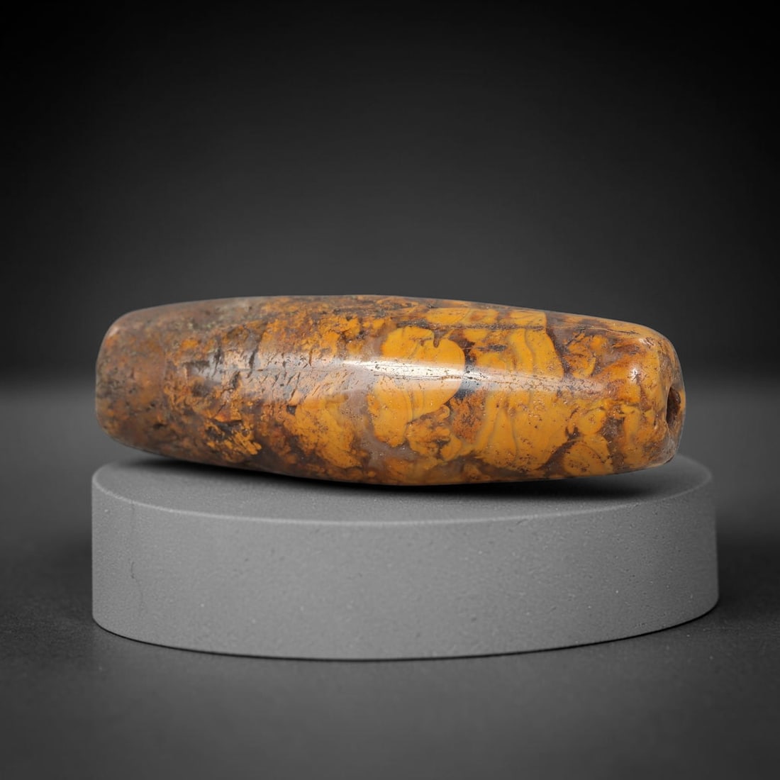 Ancient Jasper Bead - Silk Road Cylinder Amulet: Carved from natural jasper, the bead features an elongated cylindrical barrel form with a polished surface that highlights the stone's striking golden-yellow and deep brown marbled patterning, charact