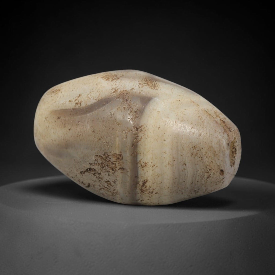 Ancient Banded Agate Bead - Western Asiatic Miniature Amulet: This bead is expertly carved from naturally banded translucent agate, showcasing fine lapidary craftsmanship consistent with the ancient bead-making traditions of the Indus Valley and Bactrian regions