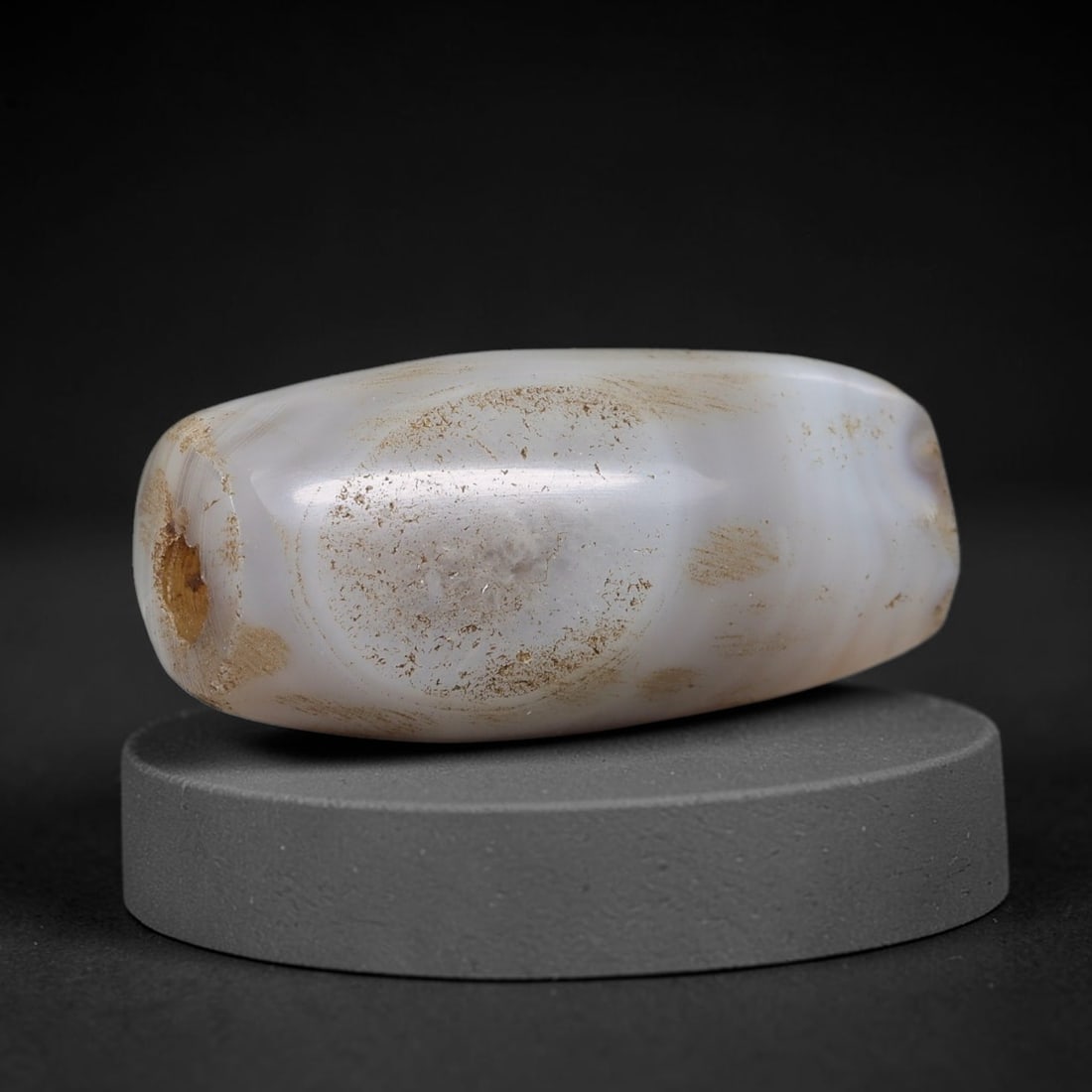 Ancient Banded Agate Bead - Indus Valley Artifact, 59BD: This artifact is crafted from natural banded agate, shaped into an elongated barrel form with a pale milky-white base and a prominent central eye-like banding pattern. The bead features a central perf