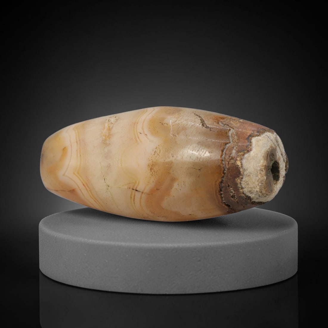 Ancient Banded Agate Bead - Western Asiatic Amulet: This bead is masterfully carved from naturally banded translucent agate, showcasing exceptional lapidary craftsmanship consistent with ancient bead-making traditions of the Indus Valley and Bactrian r