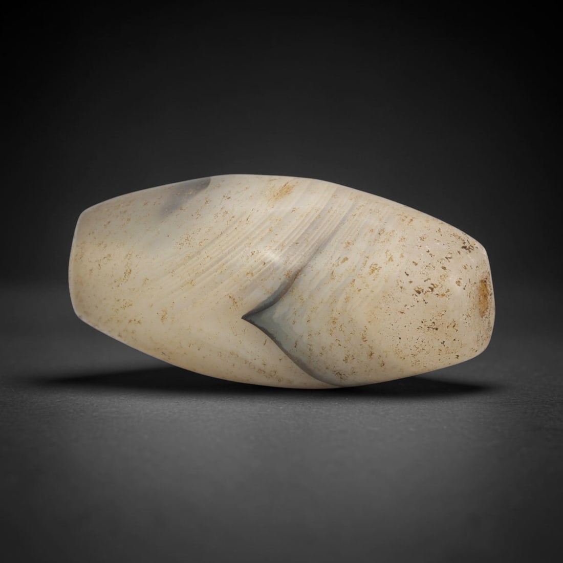 Ancient Banded Agate Bead - Indus Valley Bactrian Pendant: This bead is expertly carved from elegantly banded agate, showcasing fine lapidary craftsmanship consistent with ancient bead-making traditions of the Indus Valley and Bactrian regions. The elongated