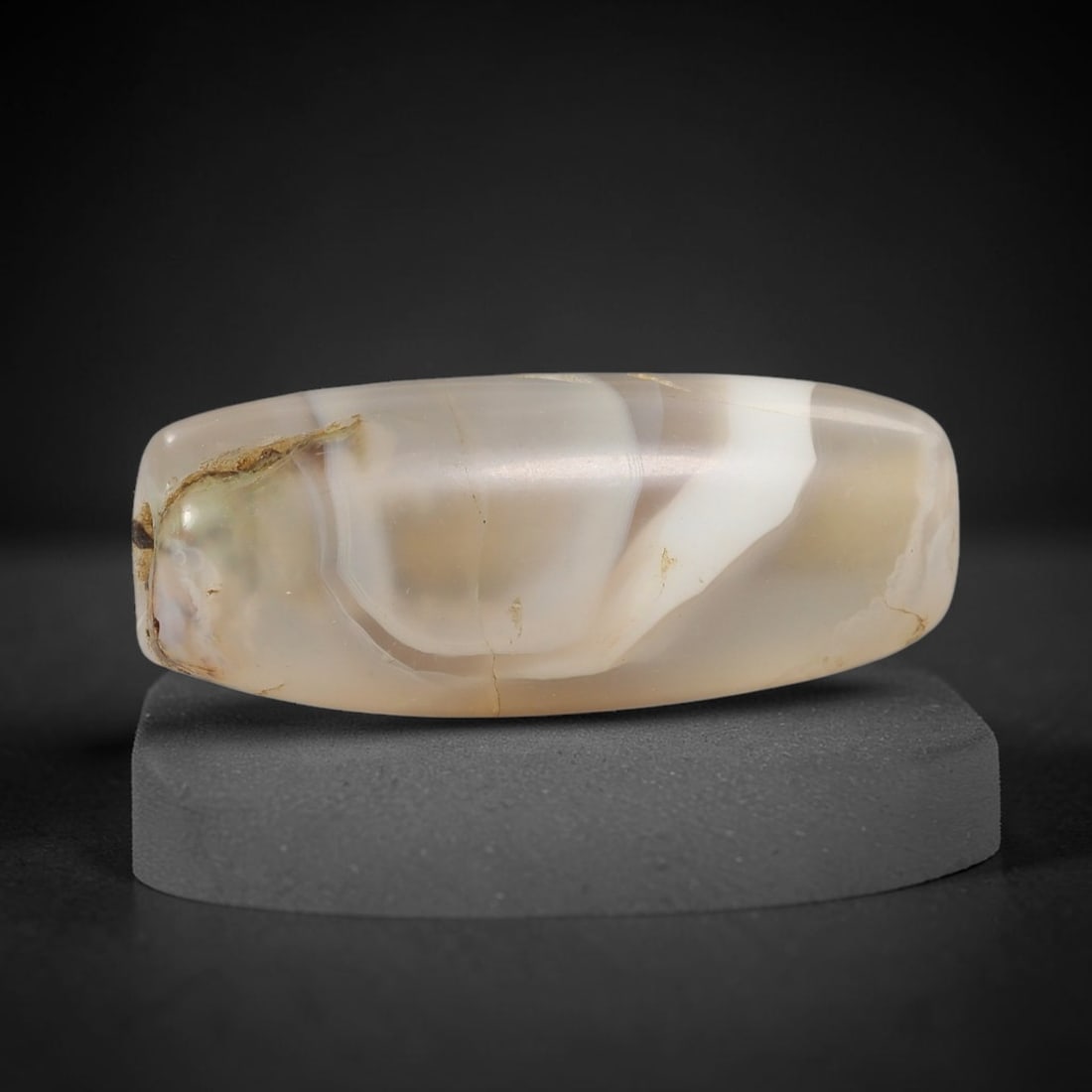 Ancient Agate Bead - Silk Road Cylinder Amulet: Carved from banded agate, the bead features a cylindrical barrel form with a smooth, polished surface that highlights the stone's natural concentric banding, ranging from translucent milky white to wa