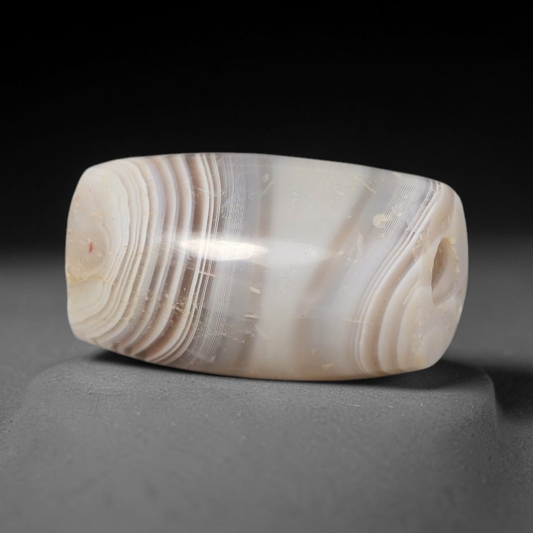 Ancient Agate Bead - Silk Road Miniature Cylinder Amulet, 93BD: Carved from banded agate, the bead features a smooth cylindrical barrel form with a polished surface that highlights the stone's striking fine parallel concentric banding, ranging from creamy white to