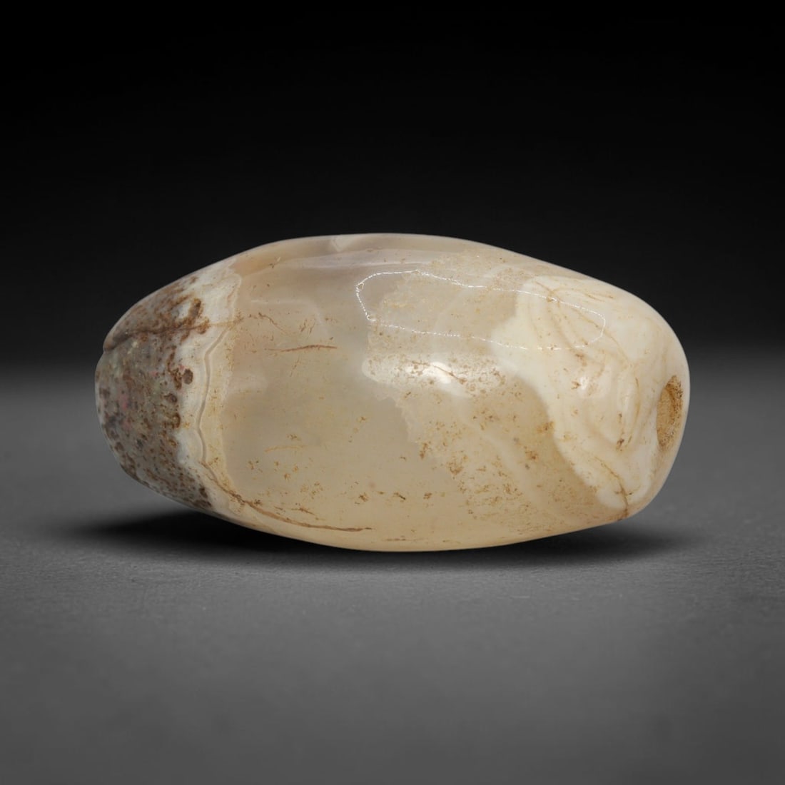 Ancient Banded Agate Bead - Indus Valley Bactrian Pendant: This bead is masterfully carved from translucent banded agate, showcasing exceptional lapidary craftsmanship consistent with ancient bead-making traditions of the Indus Valley and Bactrian regions. Th