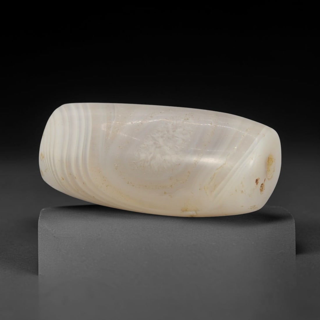 Ancient Banded Agate Bead - Indus Valley Bactrian Pendant: This bead is masterfully carved from elegantly banded translucent agate, showcasing exceptional lapidary craftsmanship consistent with ancient bead-making traditions of the Indus Valley and Bactrian r