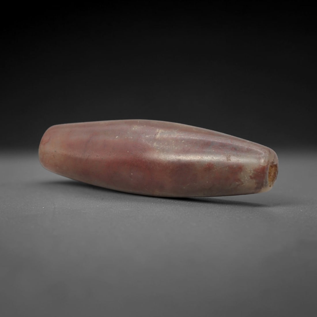 Ancient Carnelian Bead - Indus Valley Bactrian Pendant: This bead is masterfully carved from natural carnelian, showcasing exceptional lapidary craftsmanship consistent with ancient bead-making traditions of the Indus Valley and Bactrian regions. The elong