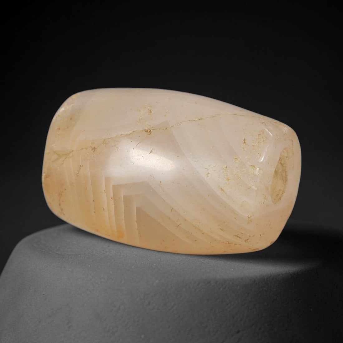 Ancient Agate Bead - Silk Road Miniature Cylinder Amulet: Carved from translucent chalcedony (agate), the bead features a smooth cylindrical barrel form with a polished surface that highlights the stone's pale milky-white base and striking hand-carved chevro