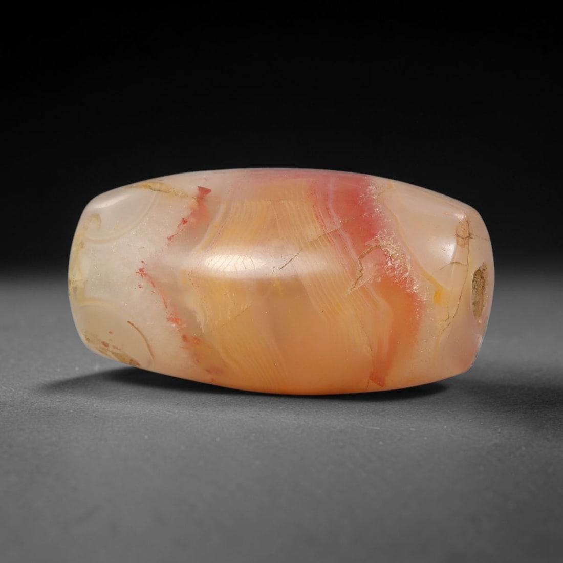 Ancient Agate Bead - Silk Road Cylinder Amulet: Carved from banded agate, the bead exhibits a cylindrical barrel form with a smooth, polished surface that highlights the stone's natural concentric banding, ranging from translucent milky white and w
