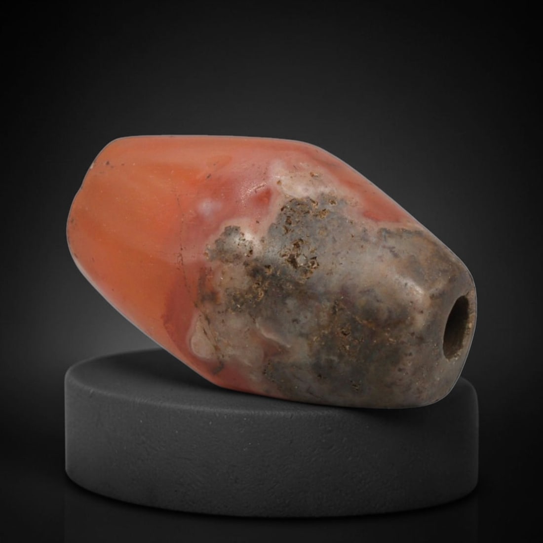 Ancient Carnelian Bead - Indus Valley Bactrian Miniature Amulet: This bead is masterfully carved from natural carnelian, showcasing exceptional lapidary craftsmanship consistent with ancient bead-making traditions of the Indus Valley and Bactrian regions. The elong