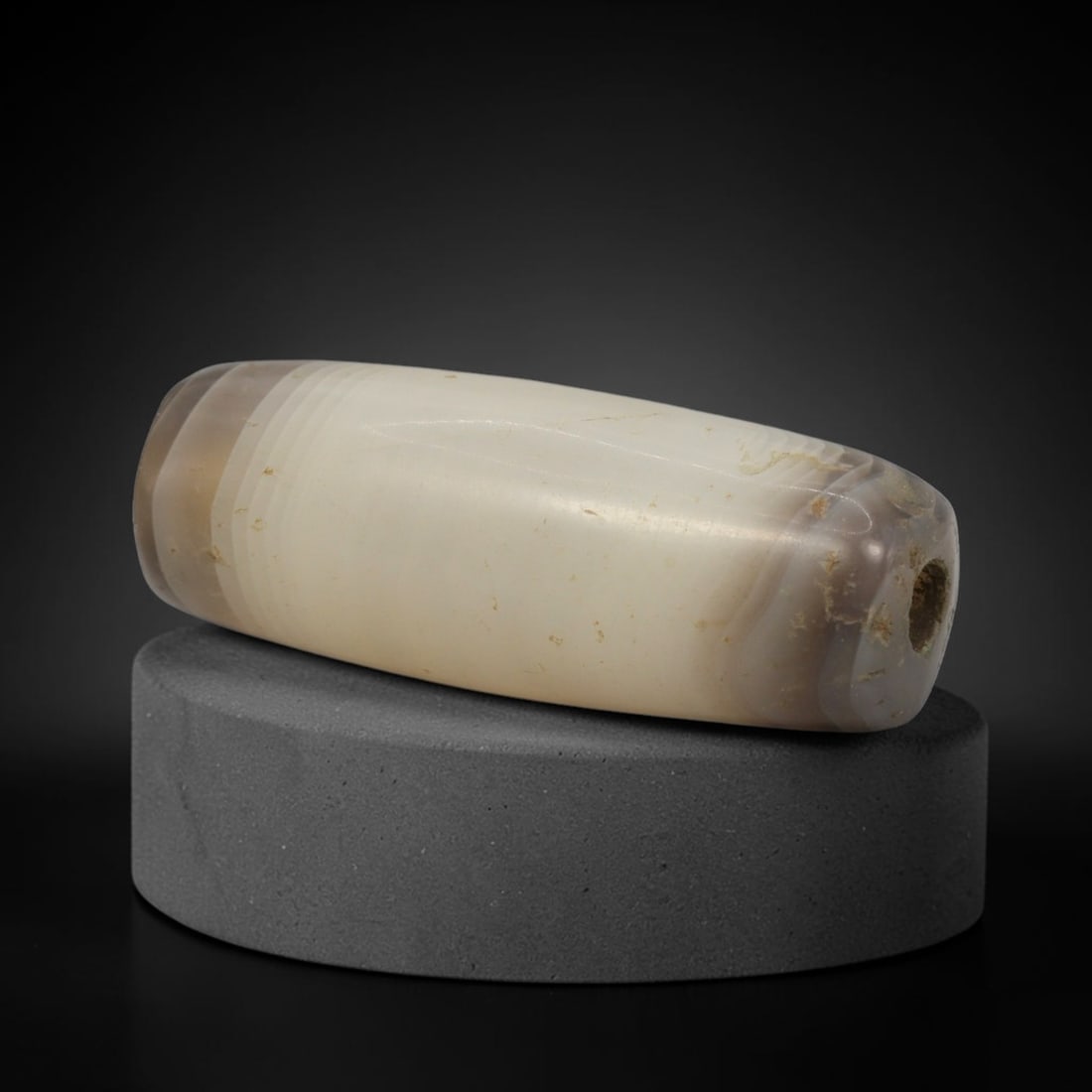 Ancient Banded Agate Bead - Indus Valley Bactrian Amulet: This bead is expertly carved from subtly banded translucent agate, showcasing masterful lapidary craftsmanship consistent with ancient bead-making traditions of the Indus Valley and Bactrian regions.