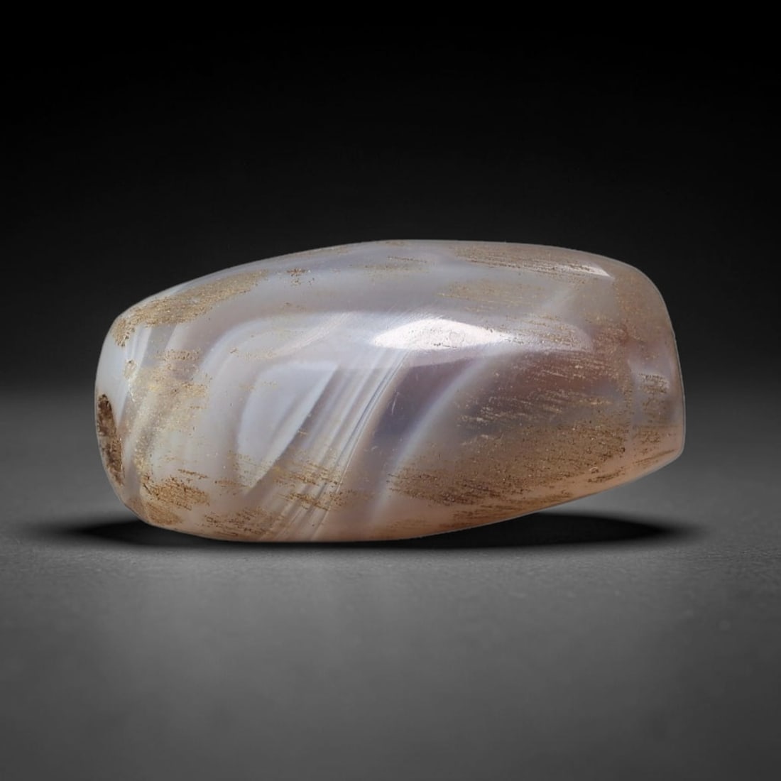 Ancient Agate Bead - Silk Road Cylinder Amulet: Carved from banded agate, the bead features a smooth cylindrical barrel form with a polished surface that highlights the stone's natural wavy concentric banding, ranging from milky white and soft lave