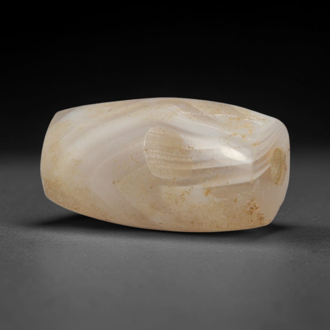 Ancient Banded Agate Bead - Western Asiatic Talisman: This bead is expertly carved from richly banded agate, showcasing fine lapidary craftsmanship associated with ancient Western Asian (likely Bactrian or Indus Valley) trade traditions. The compact barr