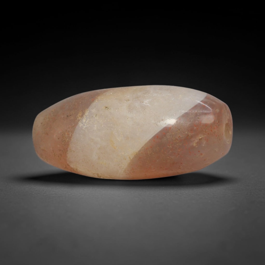 Ancient Banded Agate Bead - Silk Road Bactrian Amulet: This bead is expertly carved from contrasting banded agate, showcasing fine lapidary craftsmanship characteristic of ancient Bactrian and Silk Road trade traditions. The elongated ovoid form features