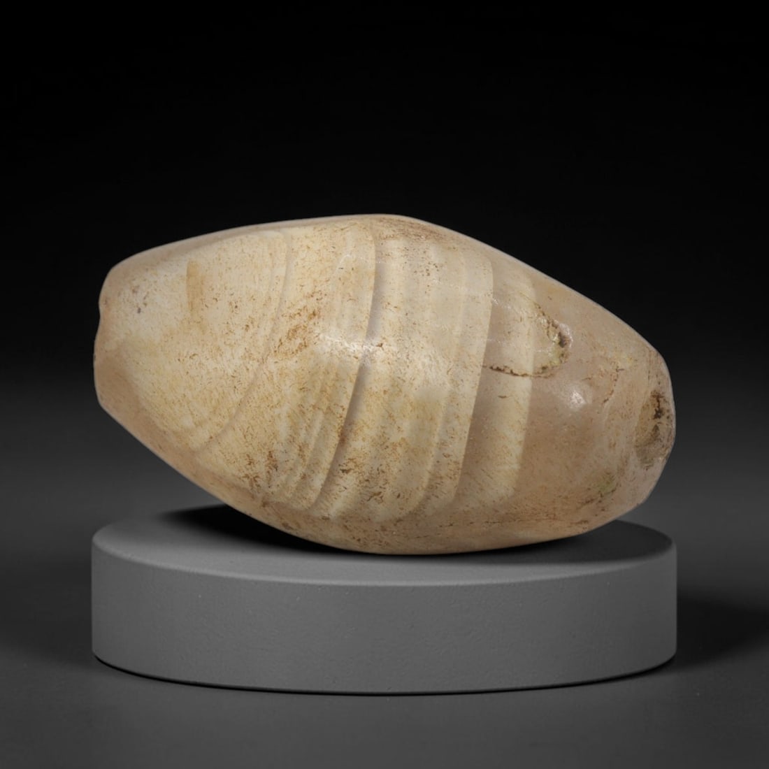 Ancient Banded Agate Bead - Western Asiatic Talisman: This bead is expertly carved from banded agate, showcasing classic lapidary craftsmanship associated with ancient Western Asian (likely Bactrian or Indus Valley) trade traditions. The ovoid form featu