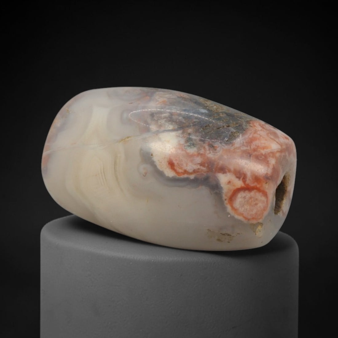 Ancient Agate Bead - Silk Road Bactrian Amulet: This bead is carved from naturally patterned agate, exhibiting fine lapidary craftsmanship consistent with ancient bead-making traditions of the Bactrian and Silk Road regions. The barrel form feature