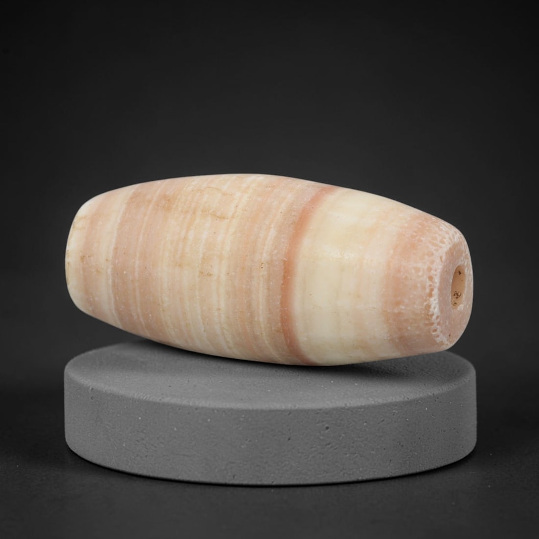Ancient Banded Agate Bead - Western Asiatic Amulet: This bead is masterfully carved from naturally banded translucent agate, showcasing exceptional lapidary craftsmanship consistent with ancient bead-making traditions of the Indus Valley and Bactrian r