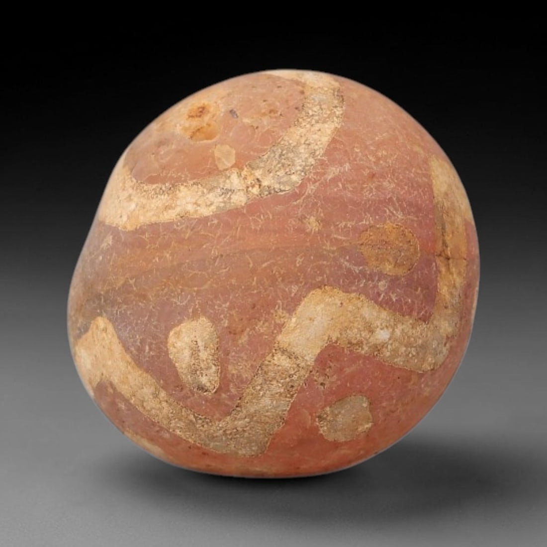 Ancient Carnelian Bead - Gandhara Etched Amulet (Sphere Form), 30BE: This ancient Gandhara etched carnelian bead takes the form of a rounded sphere, crafted from rich pinkish-red carnelian with hand-etched abstract geometric and circular motifs characteristic of Gandha