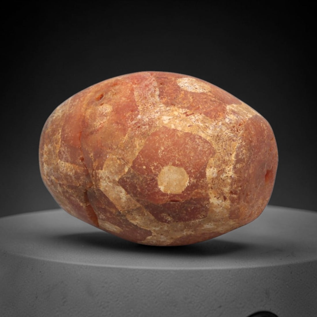 Ancient Carnelian Etched Bead - Gandhara Amulet, 43XY: Carved from carnelian, the bead is fashioned in a rounded oval form with a lateral drilled suspension hole for wear. The surface bears a partial white-etched geometric pattern of hexagonal and circula