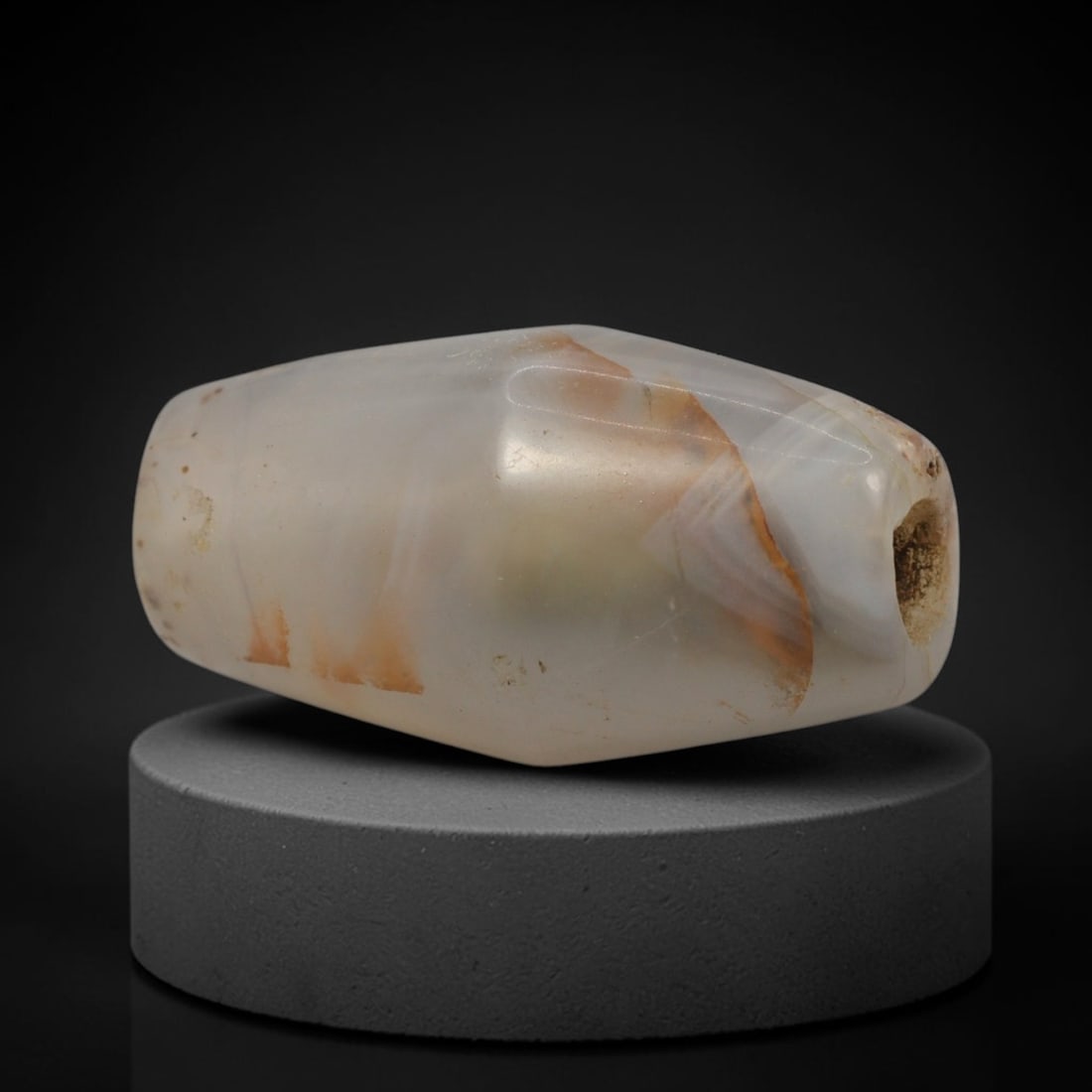 Ancient Agate Bead - Western Asiatic Faceted Bead, 59XW: This bead is carved from translucent milky-white agate with warm amber and rust-colored mineral inclusions, shaped into a refined faceted barrel form with a precisely centered axial drill hole, charac