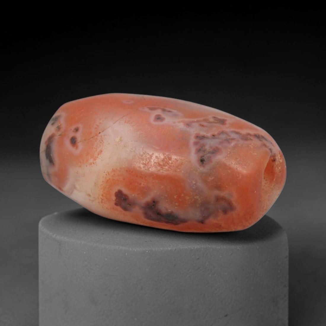 Ancient Agate Bead - Bactrian Jasper Amulet, 75XW: This bead is carved from banded carnelian-agate with vibrant orange-red, creamy white, and dark brown inclusions, exemplifying the skilled lapidary craftsmanship of ancient Bactrian and Western Asiati