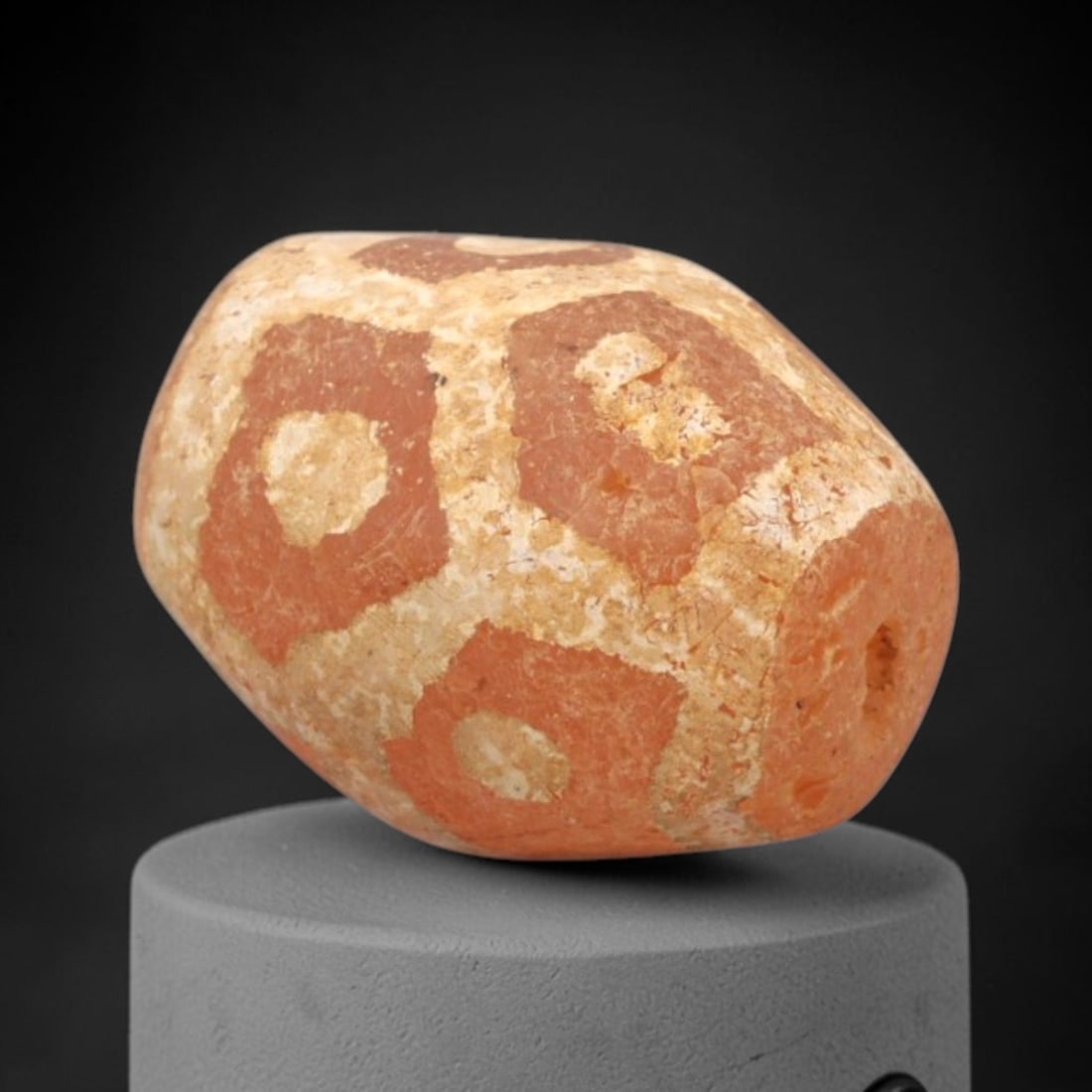 Ancient Carnelian Etched Bead - Gandhara Amulet, 36XY: Carved from carnelian, the bead is fashioned in a barrel-shaped form with a lateral drilled suspension hole for wear. The surface is decorated with a bold geometric pattern of red diamond-shaped field