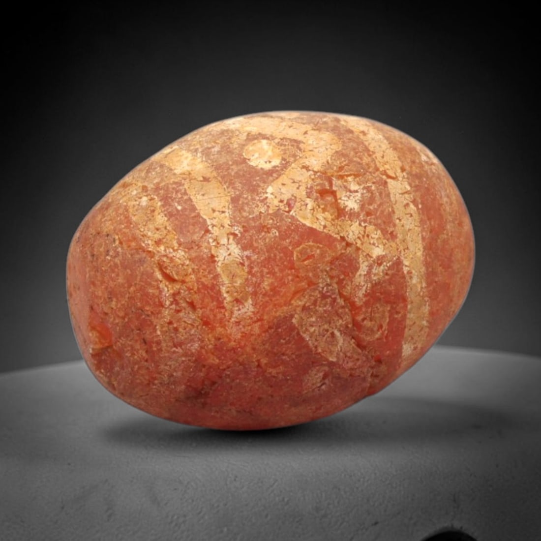 Ancient Carnelian Etched Bead - Gandhara Amulet, 35XY: Carved from carnelian, the bead is fashioned in a rounded, oval form with a lateral drilled suspension hole for wear. The surface bears a partial white-etched geometric motif, characteristic of Gandha