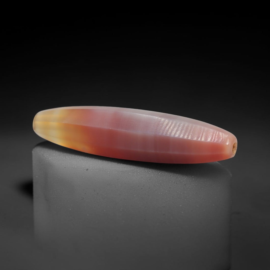 Antique Idar-Oberstein Banded Agate Spindle Bead, 1XW: A single antique spindle-shaped banded agate bead, crafted in the historic Idar-Oberstein region of Germany, a world-renowned center for gemstone cutting and beadmaking. The bead features striking nat
