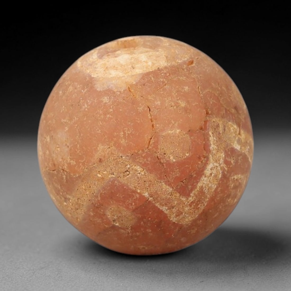 Ancient Gandhara Carnelian Etched Bead, 28BE: Carved from natural carnelian, this spherical bead features subtle white etched geometric motifs across its surface, with a lateral drilled suspension hole consistent with Gandharan bead manufacturing