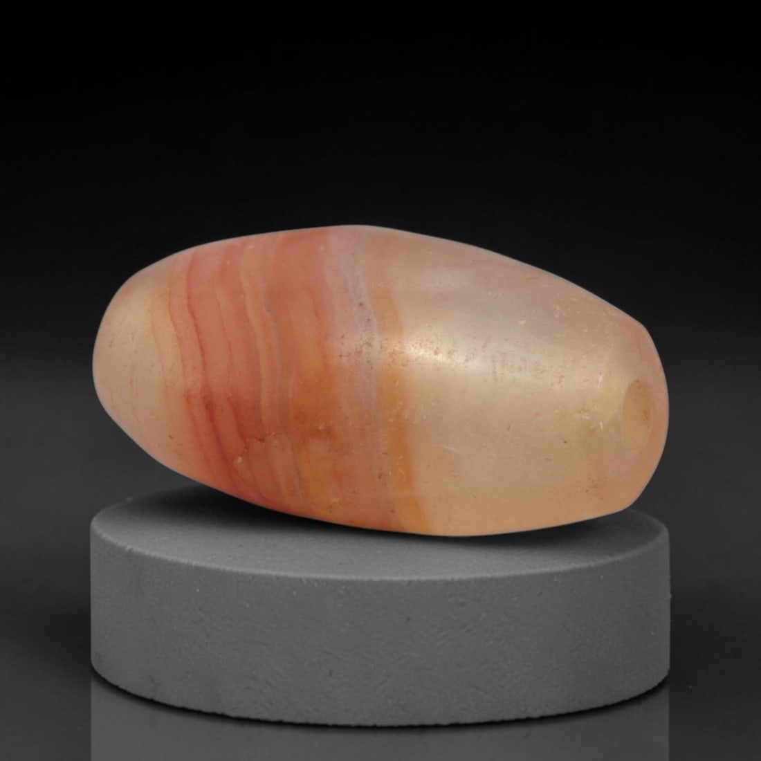 Ancient Banded Carnelian Agate Bead - Western Asiatic Amulet, 6XY: This bead is expertly carved from natural banded carnelian agate, showcasing fine lapidary craftsmanship consistent with ancient bead-making traditions of the Indus Valley and Bactrian regions. The el