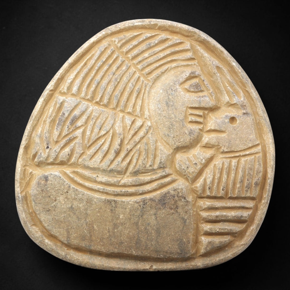 Ancient Stone Plaque Relief - Near Eastern Human & Feline Figural Plaque, 18ZY: Carved from a single piece of stone, this rounded triangular relief plaque depicts a stylized human figure in profile facing a feline, rendered in the linear, incised artistic tradition of the ancient