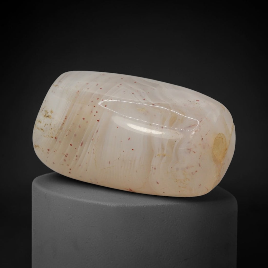 Ancient Agate Bead - Indus Valley Banded Barrel Bead with Red Hematite Inclusions, 3XW: This bead is carved from translucent creamy-white banded agate, shaped into a smooth, compact barrel form with a precisely centered axial drill hole, characteristic of Indus Valley (Harappan) lapidary