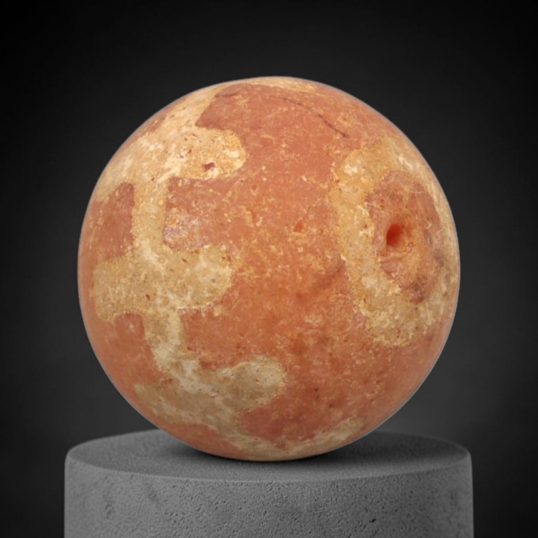 Ancient Carnelian Etched Bead - Gandhara Spherical Bead, 57XY: The bead is crafted from carnelian, a semi-precious chalcedony, with a spherical form and laterally drilled suspension hole. Its surface features an etched white pattern of angular and irregular geome