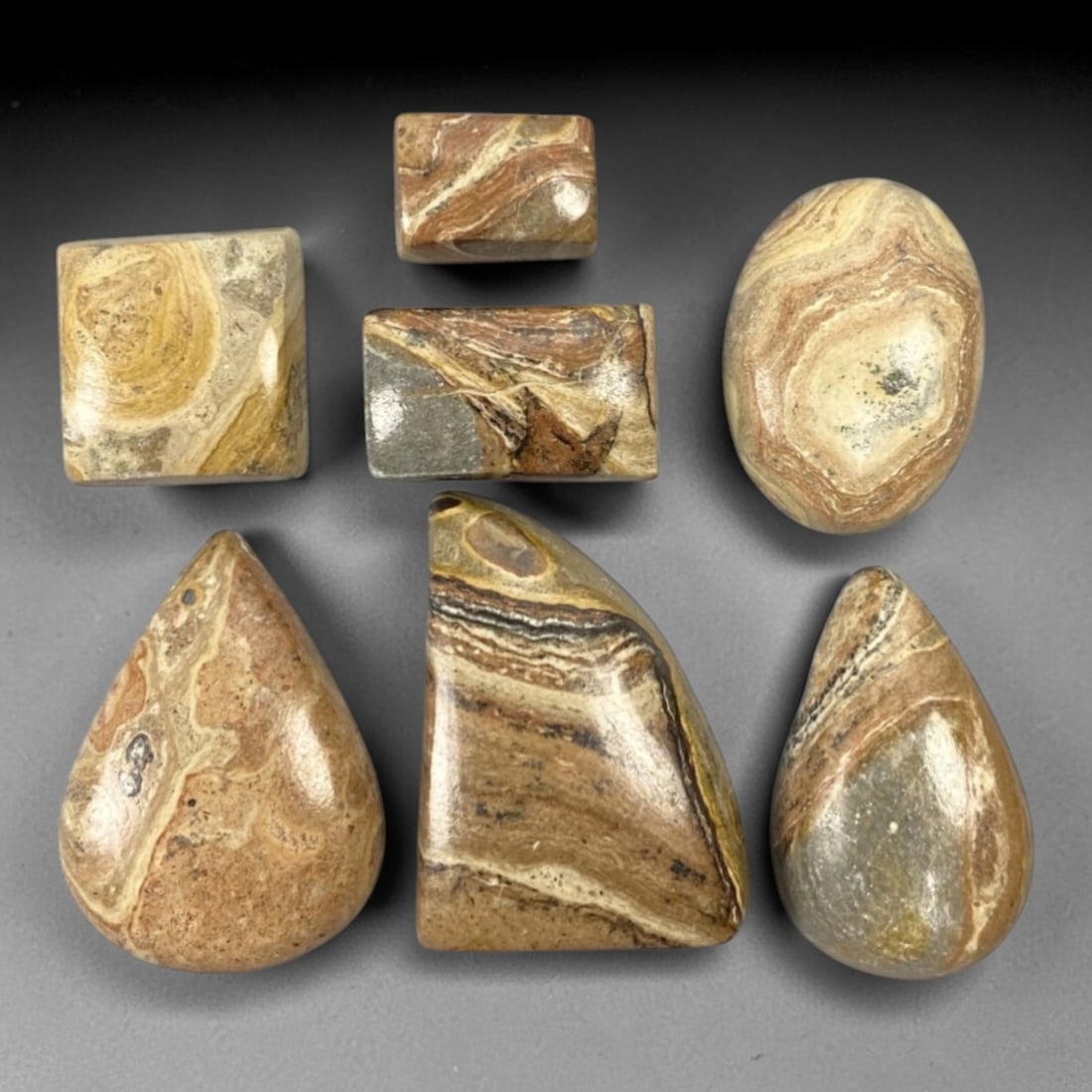 126.92 Carats Banded Jasper Cabochon Parcel - Natural Loose Gemstones, 97ZL: This substantial parcel of banded jasper cabochons, weighing a total of 126.92 carats with individual dimensions ranging from 1.3 to 2.7 cm, showcases the gemstone's iconic layered patterns in warm ea