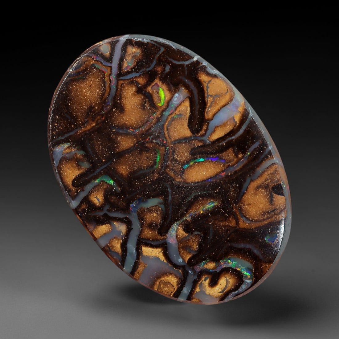 5.11 Carats Koroit Boulder Opal Cabochon - Natural Australian Stones 13.3x9.5mm, 13XM: This exceptional 5.11-carat Koroit boulder opal cabochon is a natural masterpiece, showcasing a dense, intricate tapestry of multicolored play-of-color set within a rich, earthy ironstone matrix. The