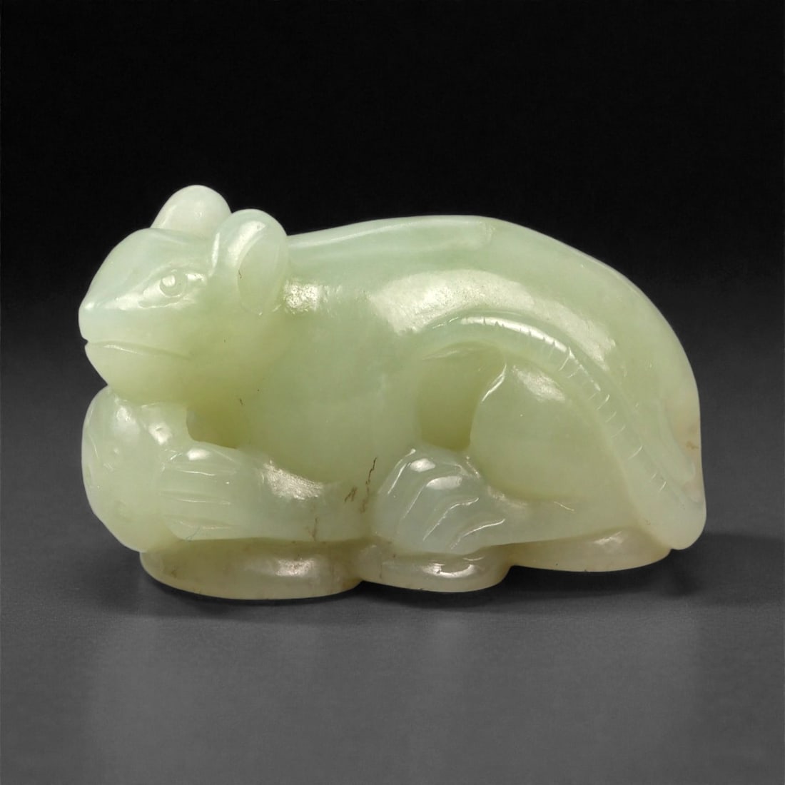 Chinese Jade Mouse - Carved Animal Figurine 3.8cm, 84ZC: Carved from pale green jade with milky translucency and gentle tonal variation, this small sculptural figure represents a mouse rendered in a compact crouching posture. The carving is executed fully i