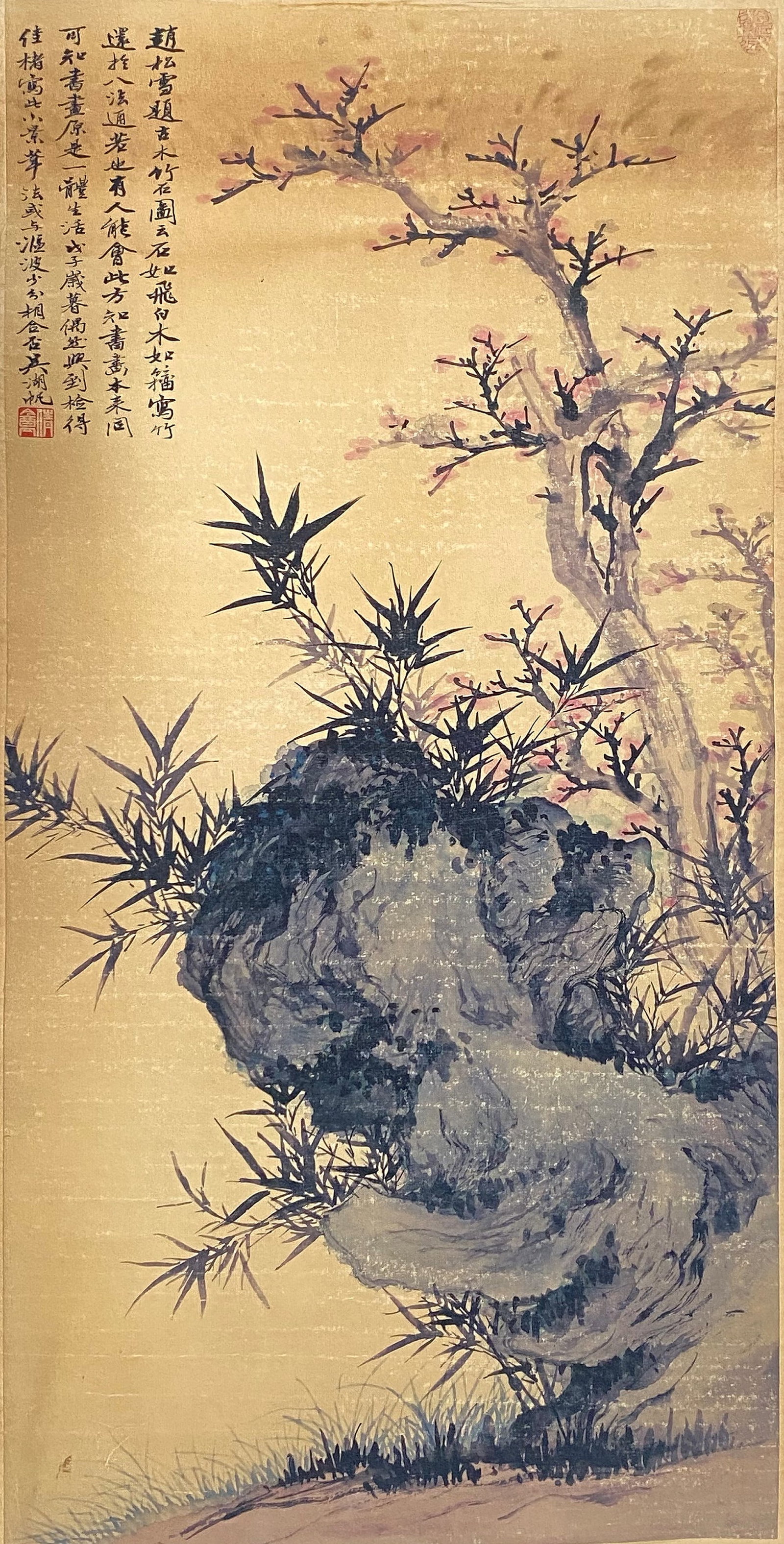 A Chinese Ink and Color Art Print of Prunus, Bamboo, and Scholar's Rock, 20th Century, 20FK: Produced using fine art printing processes on aged paper stock, the work is an ink and color art print executed in the traditional Chinese bird-and-flower painting idiom. The composition features a gn